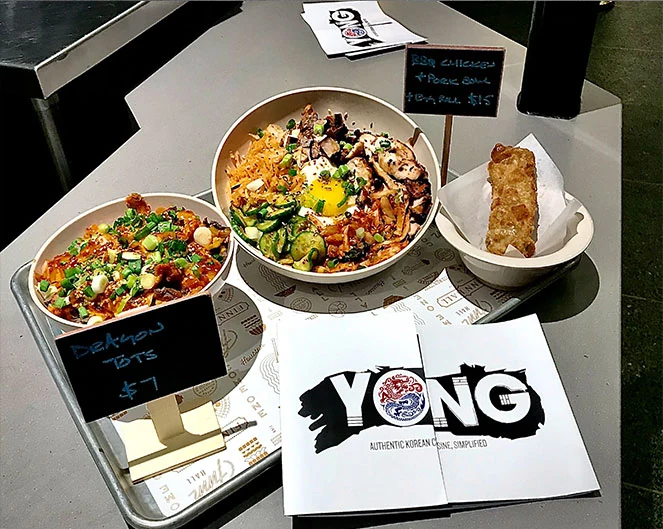 YONG dishes and printed gatefold menu on the counter